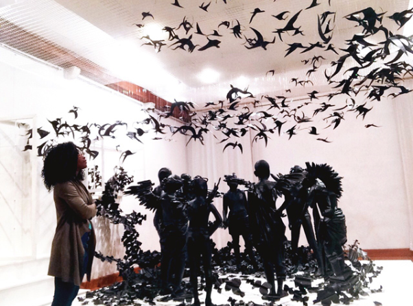 SHARON OBUOBI WITH PEJU ALATISE’S FLYING GIRLS INSTALLATION. PHOTO © SHARON OBUOBI