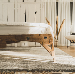 Oak bed handmade in room design closeup