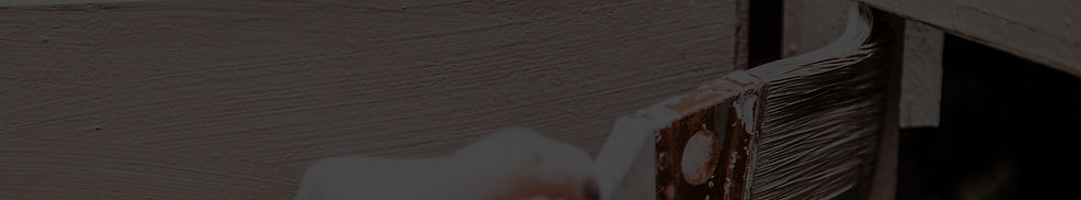 A close-up image of a paintbrush carefully applying a smooth coat of paint to kitchen cabinets, highlighting precision and attention to detail.