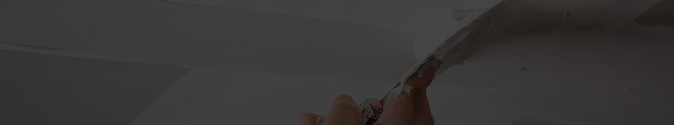 A picture of a worker expertly spreading joint compound with a drywall spatula to finish drywall, ensuring a smooth and flawless surface for painting.
