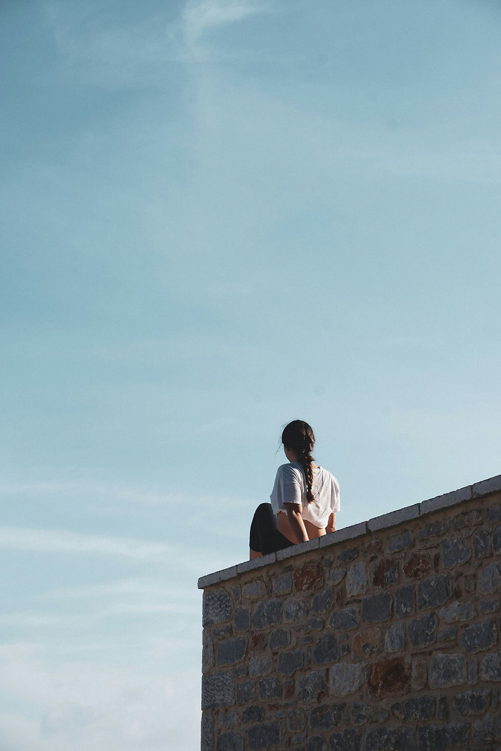 looking for god in food, disordered eating woman on wall looking at sky