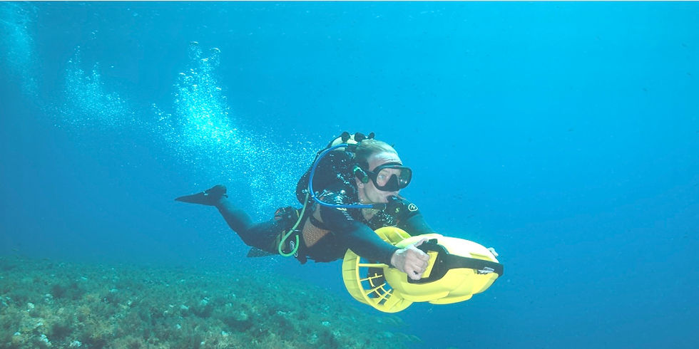 A diver explores the underwater wonders of the Balearic Islands Hope Spot in Spain using a scooter, surrounded by vibrant marine life.
