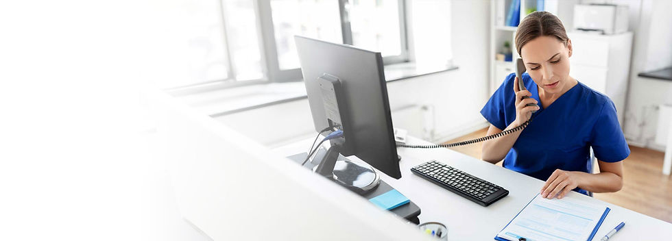 Healthcare office assistant talking on a VoIP phone at her desk