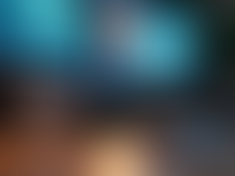 Two monitors, headphones & a keyboard sit on a home office desk.