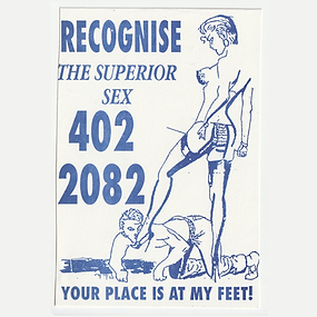 Scan of a white business card printed in blue ink, featuring a line drawing of a submissive man worshipping a  dominatrix's boots. The text reads "Recognise the Superior Sex" "Your Place Is At My Feet" and a phone number.