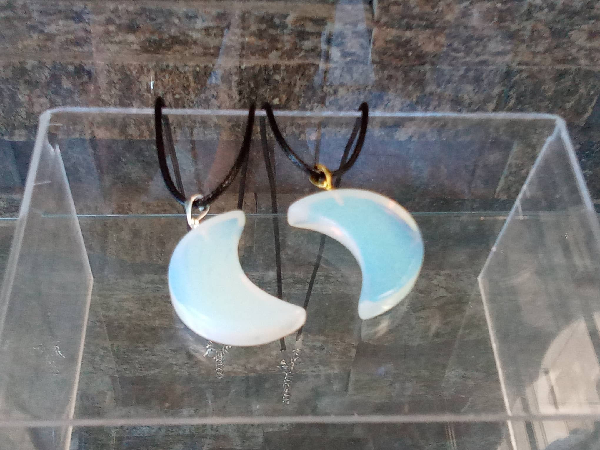 Two opal moon pendants