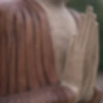 Wooden Buddha statue, hands in prayer