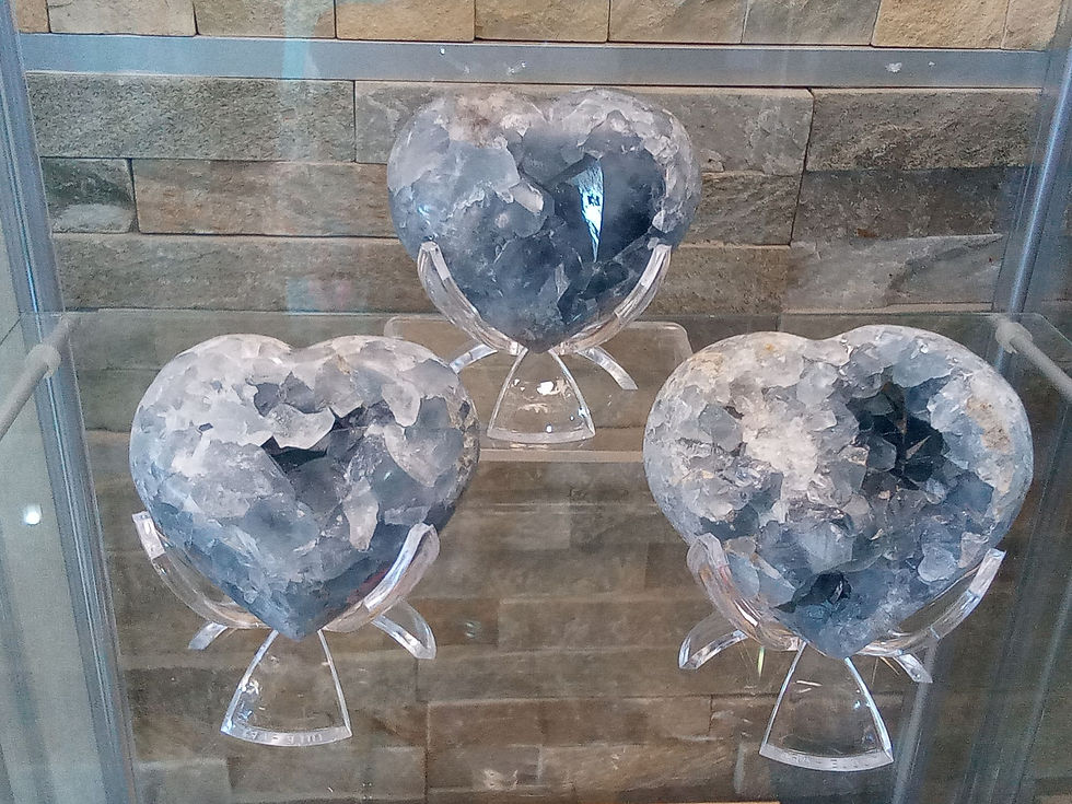 Three grey heart-shaped crystals on stands