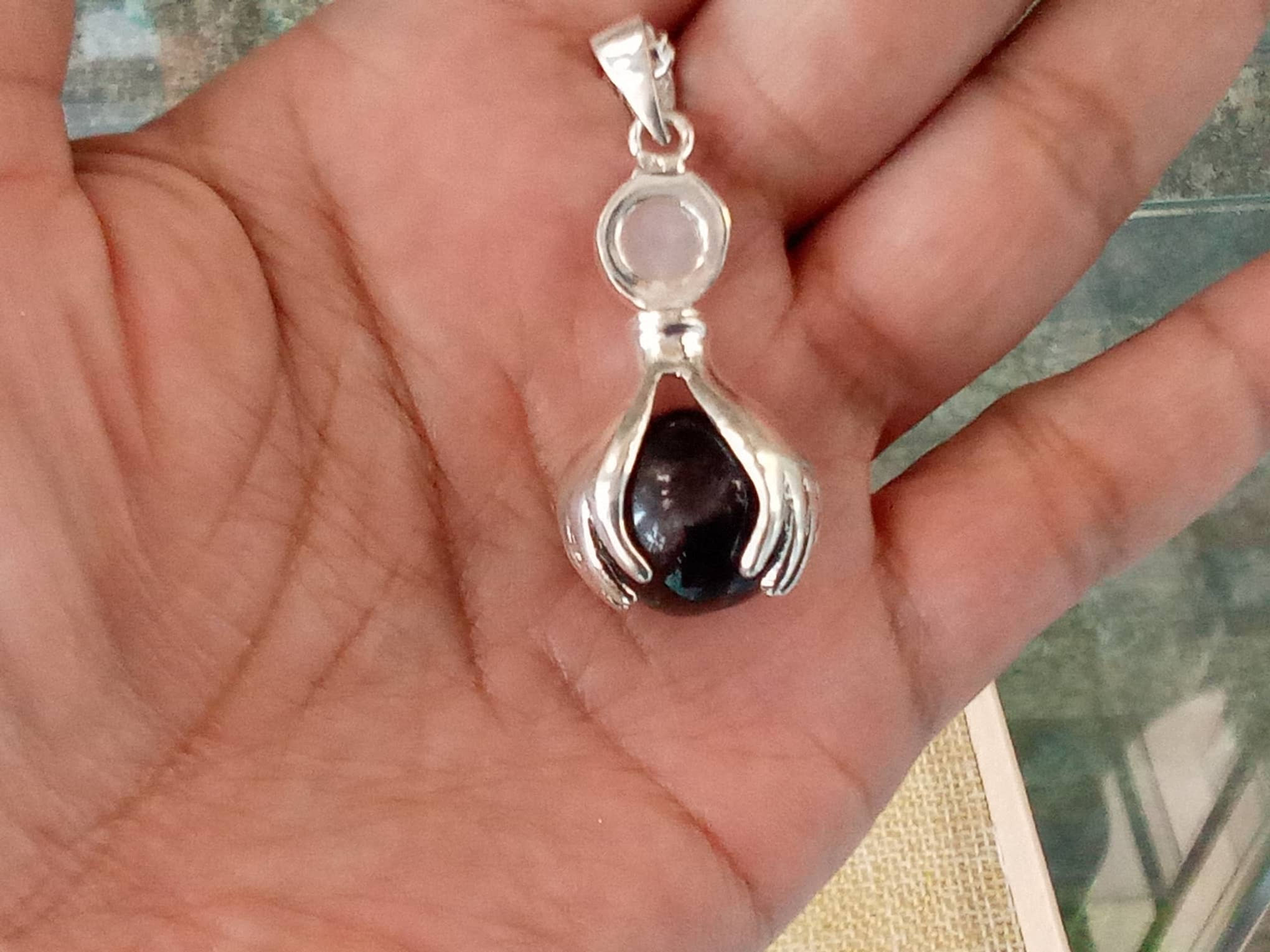 Garnet sphere pendant, silver hands, rose quartz