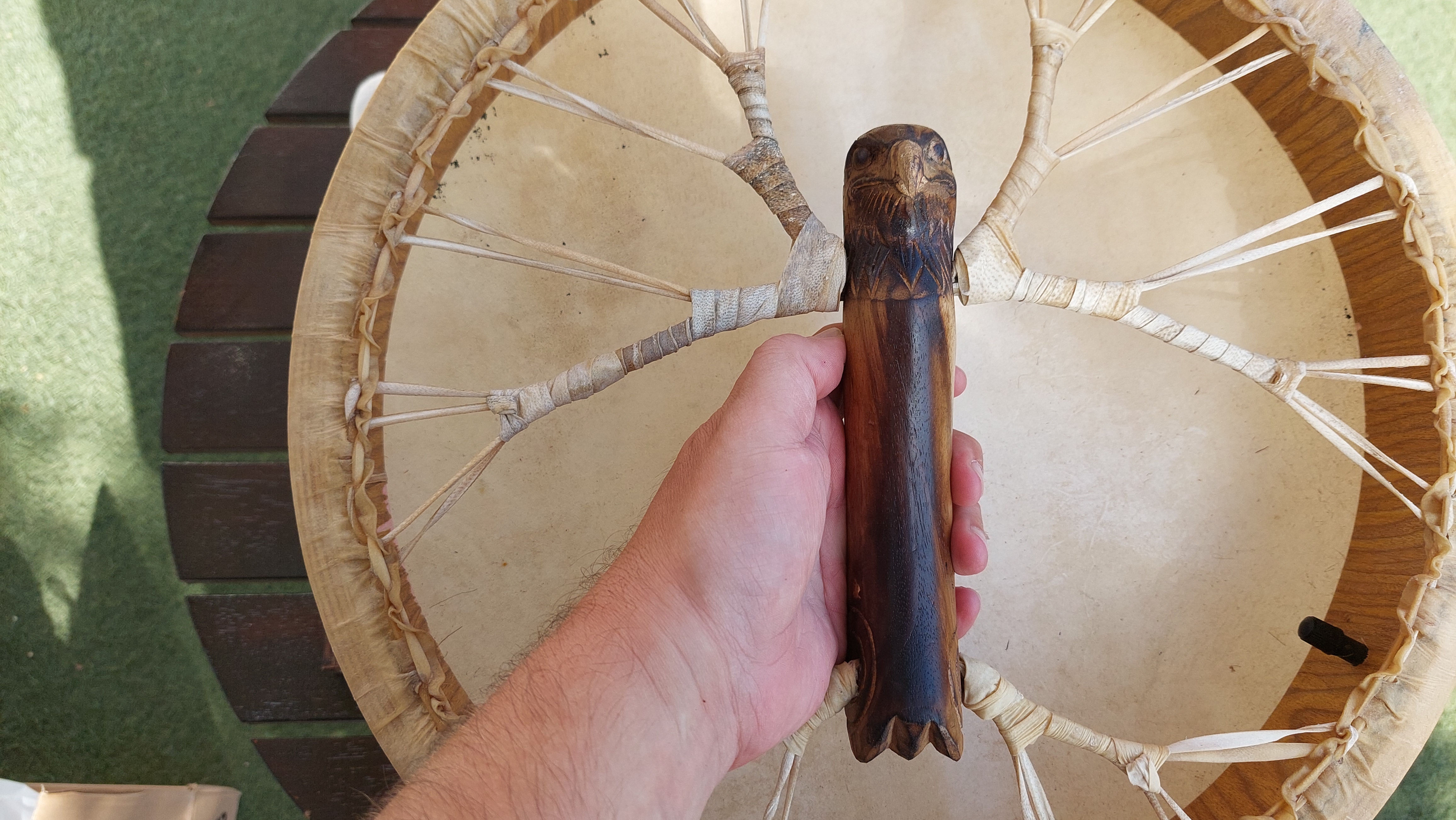 A hand holding an Eagle Shamanic Drum