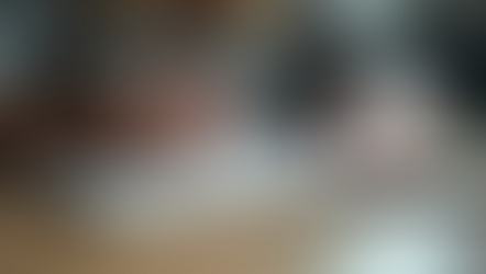 Eye-level view of a person writing notes in a journal during a coaching session