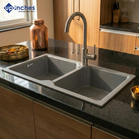 Grey quartz double-bowl kitchen sink installed with steel faucet on modern countertop, stylish contemporary kitchen look.