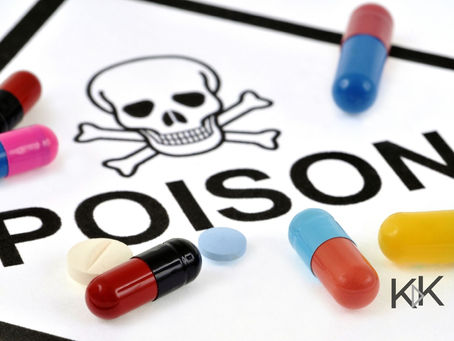 Poison and skull sign with pills laying on top.