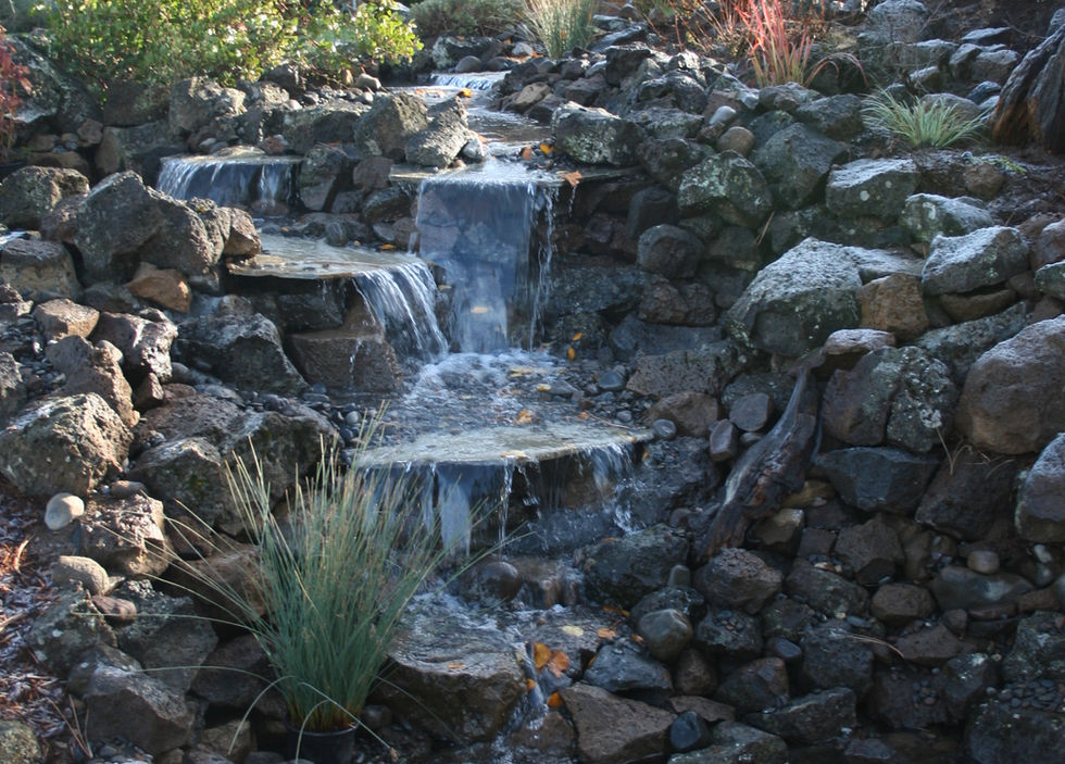 Water feature through natural stone as part of landscape design in Bend - Bend Landscape