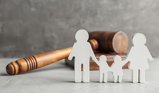 Family figure and gavel on table. Family