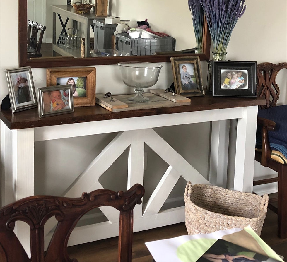 Handcrafted entryway table with dark wood top styled with decor