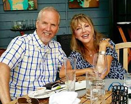 Kerry Peresta with husband Jim - Author Kerry Peresta smiling alongside her husband Jim. The couple enjoys kayaking, beach time, and exploring the scenic vistas of the Lowcountry together.