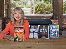 Kerry Peresta with Her Four Books - Kerry Peresta is the author of the Olivia Callahan Suspense series and writes suspense novels: The Deadening, The Rising, The Torching, and Back Before Dawn.