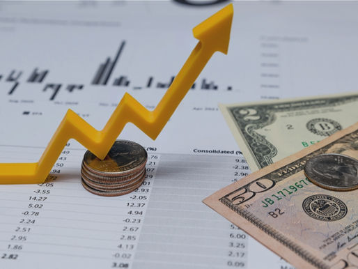 Increasing revenue graph with dollar bills and coins