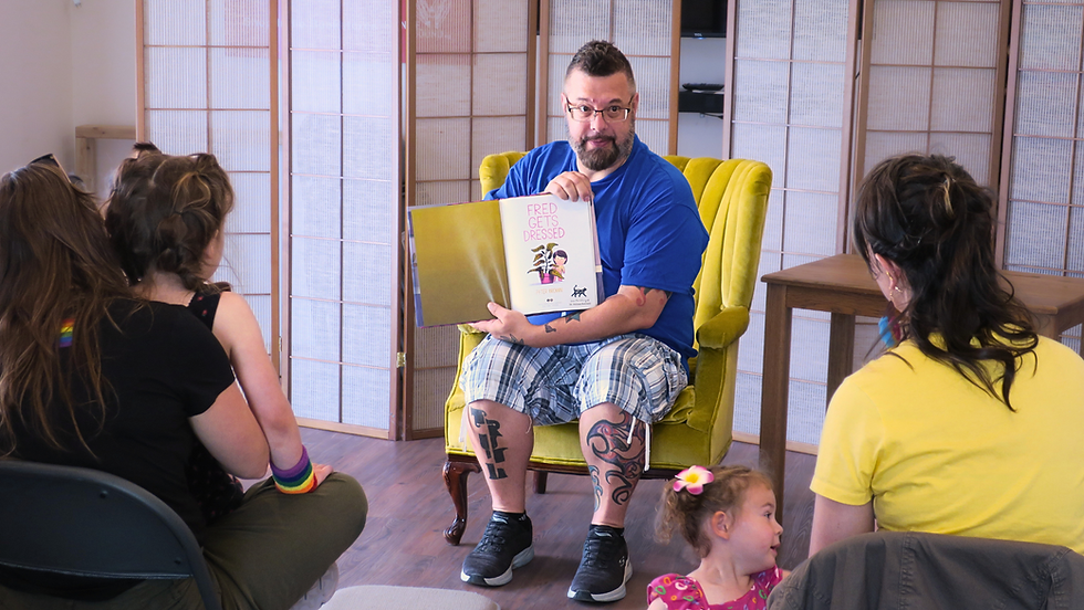Odyssey Board Member Jeremy reads to the crowd during Pride In Perry 2024.