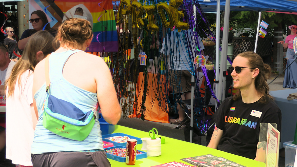 Attendees speak to a vendor during Pride In Perry 2024.