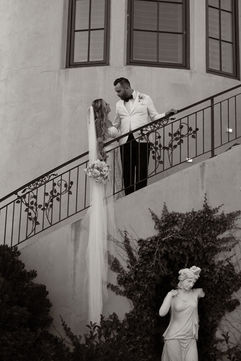Romantic black and white portrait of a bride and groom on the Villa San Juliette staircase overlooking the estate gardens in Paso Robles wine country.