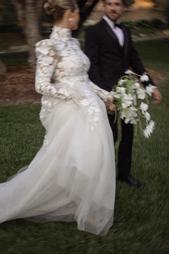 Candid wedding portrait of bride and groom walking at Villa Loriana estate in California