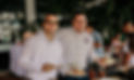 Two men smiling with plates of food