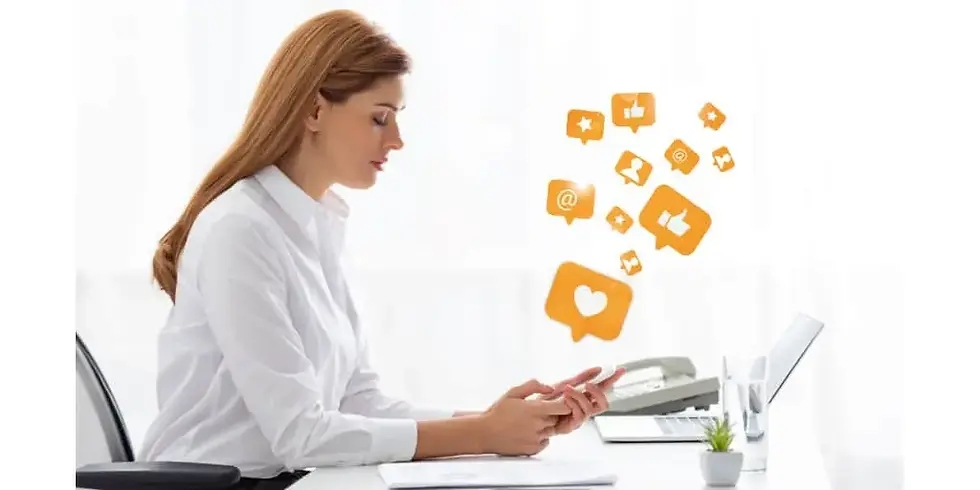 female-social-media-manager-on-smartphone-at-her-desk.webp