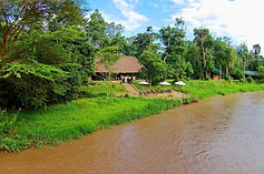 ishasha-wilderness-camp-exteriors-lodge-river-bank-01.71afd591.jpg