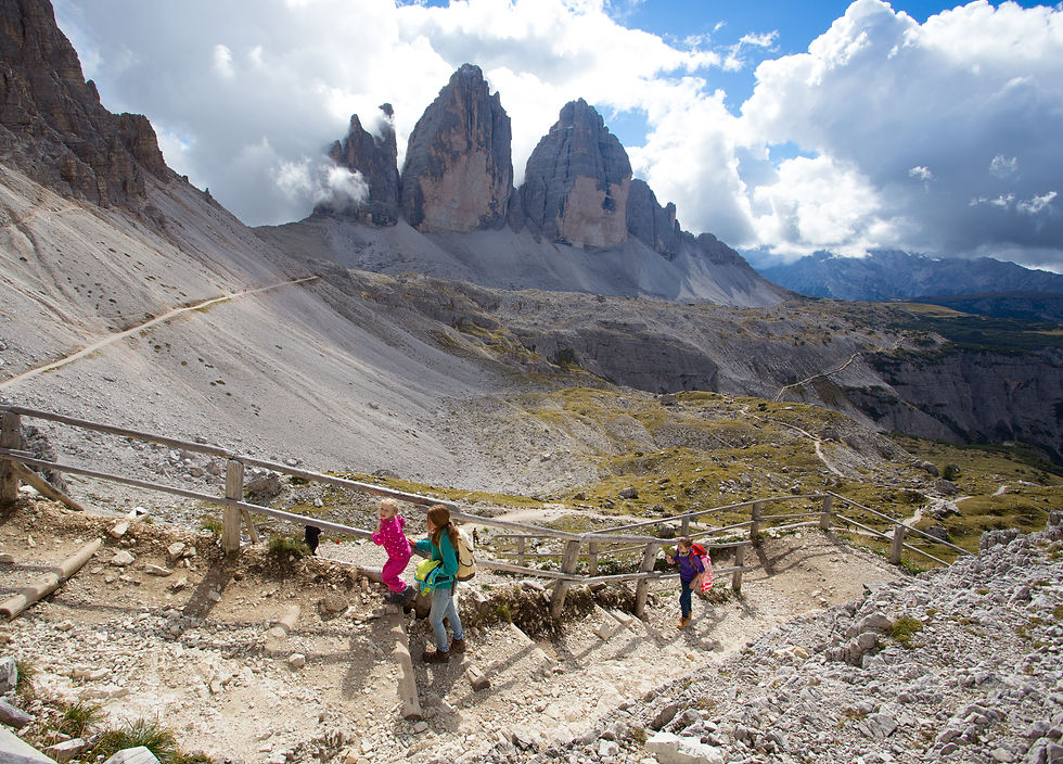 A family with children hiking along a trail at Tre Cime di Lavaredo in the Dolomites