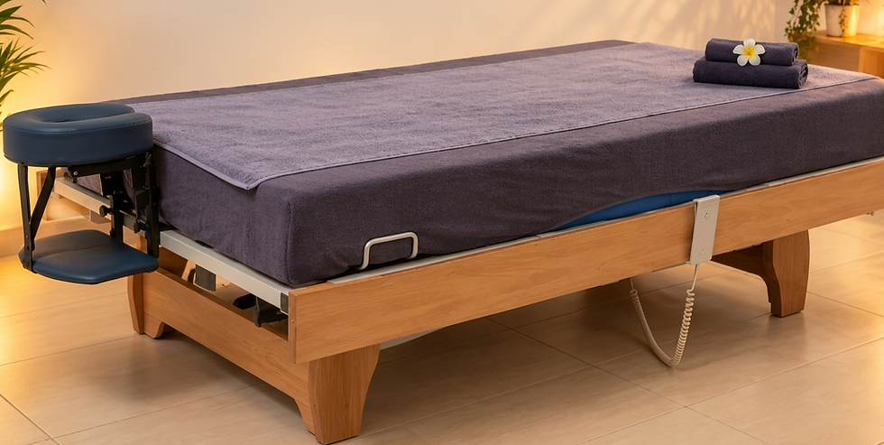 Studio photography of a modern bed or massage table with a wooden frame. Clean and comfortable setting.
