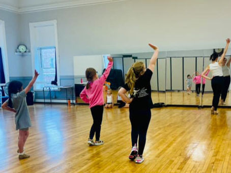 Dancers performing choreography for peers