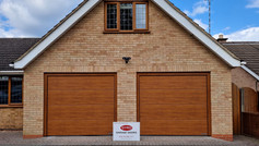 2 Hörmann L-ribbed sectional doors in Decograin golden oak