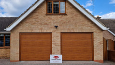 2 Hörmann L-ribbed sectional doors in Decograin golden oak