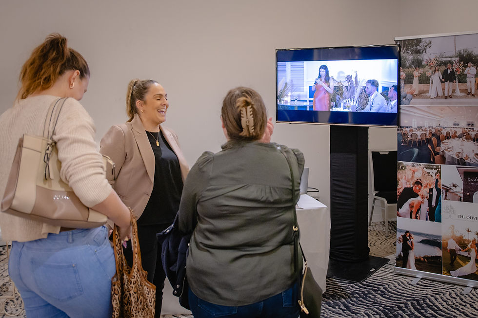 Three people talking whilst watching a TV screen