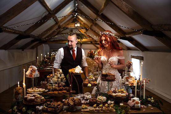 bride and groom enjoying their dessert table