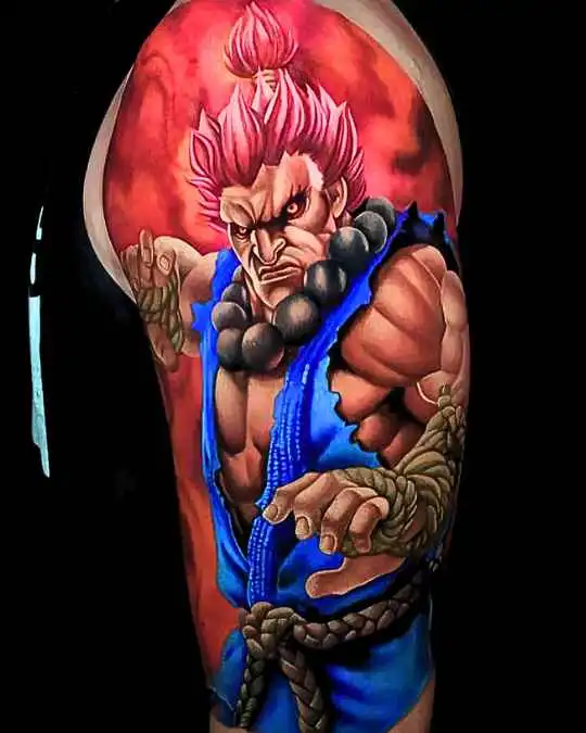 Buntes Tattoo mit Akuma von Streetfighter mit rotem Hintergrund auf der Schulter, inspiriert von Anime und Manga, gestochen im 6ink9 Tattoo Studio in Köln | Colorful tattoo of a hero with a red background on the shoulder, inspired by anime and manga, Cologne
