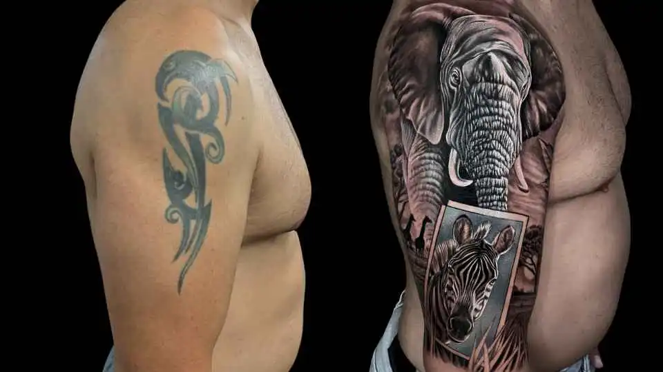 Realistisches Cover-Up-Tattoo eines Elefanten und Zebras über einem Tribal-Muster am Oberarm, gestochen im 6ink9 Tattoo Studio in Köln | Realistic cover-up tattoo of an elephant and zebra over a tribal design on the upper arm, Cologne
