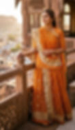 Woman in Kesariya orange georgette leheriya poshaq