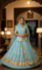 Woman in light blue Noor Rajwadi poshak standing in a palace