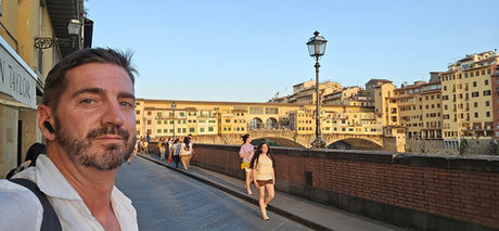 Jason Steven standing in front of the Ponte Vecchio Florence, Italy