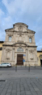 Looking up at the facade of the Church of Ognissanti in Florence, Italy