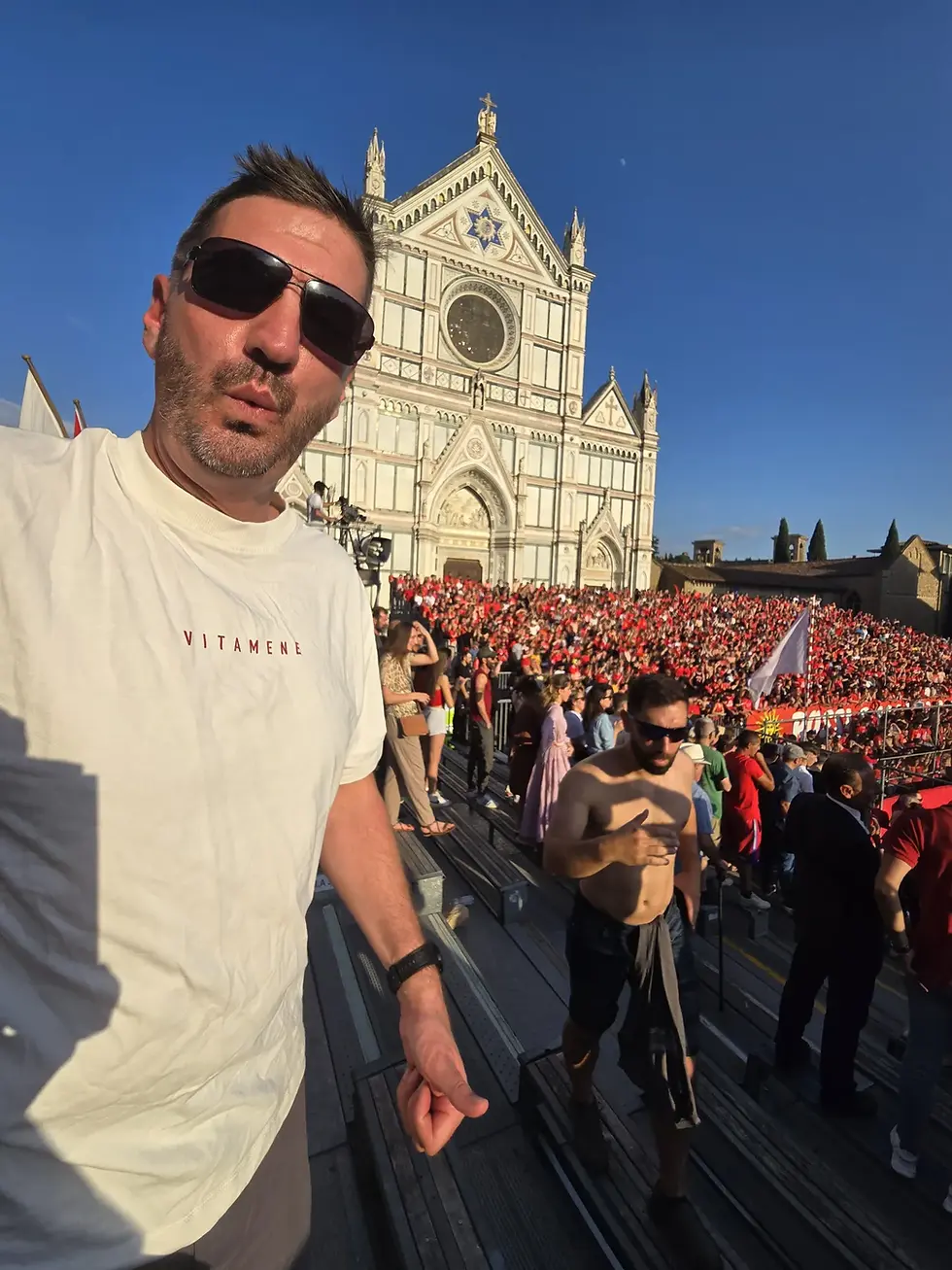 Jason in Piazza Santa Croce during Calcio Storico with the basilica behind, Florence