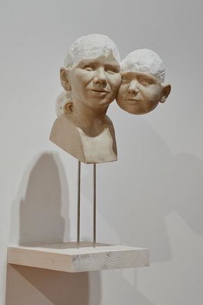 wax and polystyrene bust of Mother and daughter. Their heads are merging together