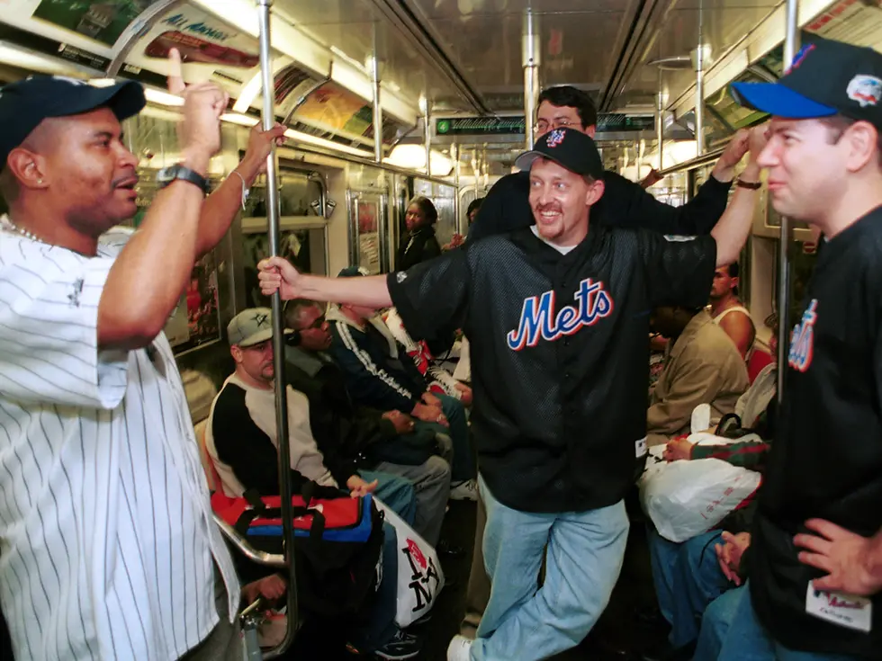 Mets and Yankees fans bantering on baseball on the NYC subway