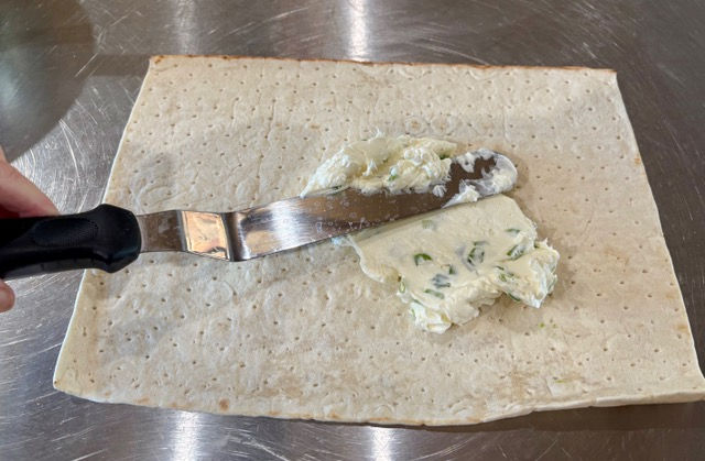 Spread the filling evenly over the lighter side of the bread.
