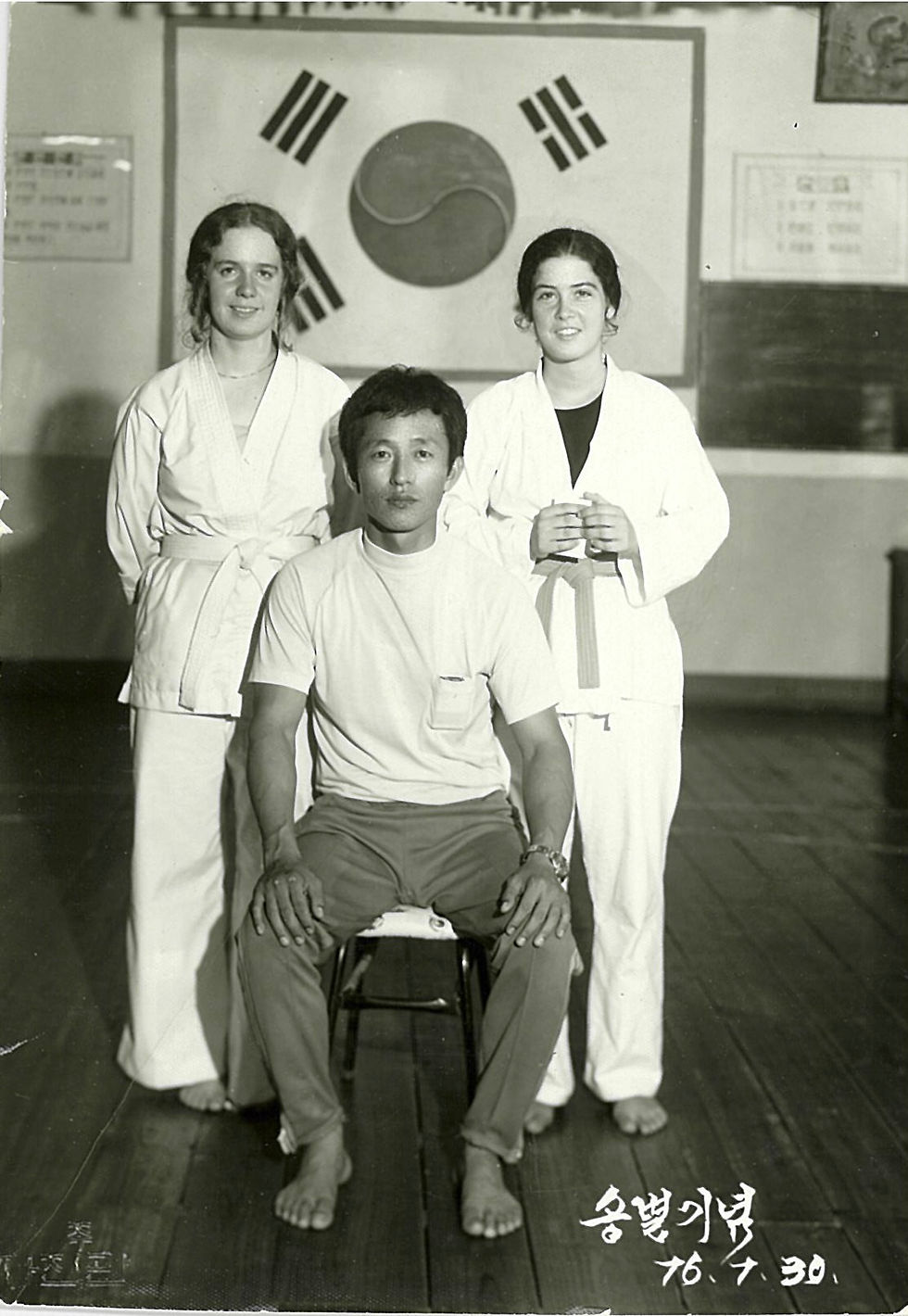 The author and one of her besties along with the master instructor of the Taekwondo gym where they studied