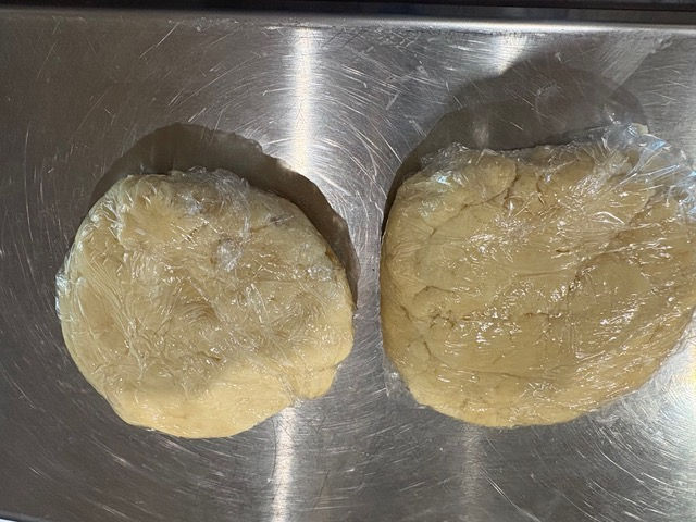 Divide into 2 balls, flatten them into discs, wrap and refrigerate.