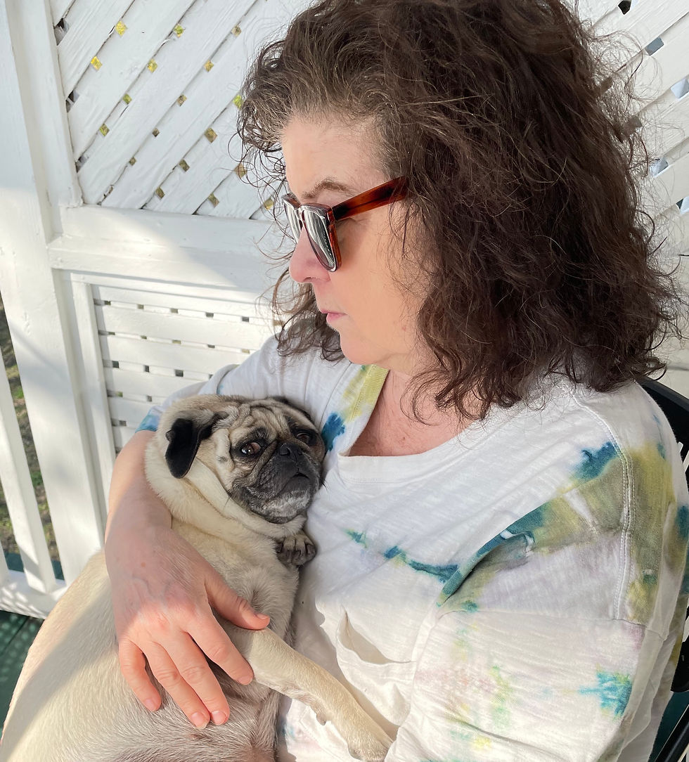 The author and Daisy, the family's rescue pug (2023)